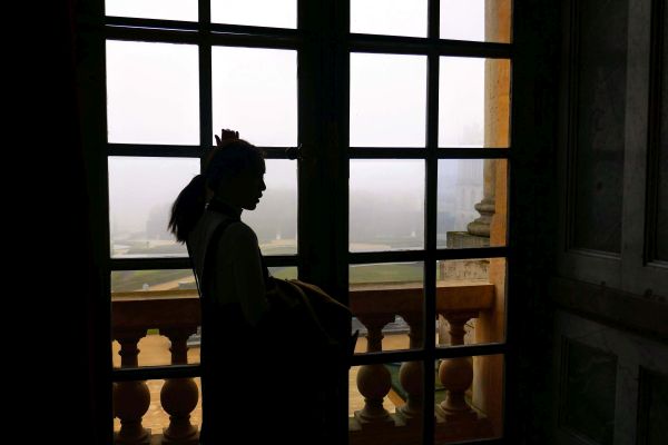 woman in front of Versailles window and panorama