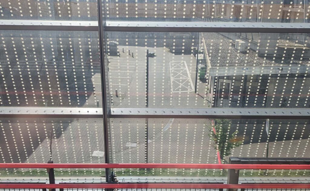 Train depot shown through fence.