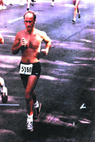 Runner descending Brady Street during the Bix 7 road race in Davenport Iowa